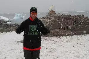 Member Posing in Antartica with Merchandise